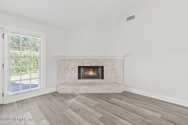 2619 Wrightson Dr, Jacksonville, FL 32223 - unfurnished living room featuring baseboards, wood finished floors, visible vents, and a high end fireplace