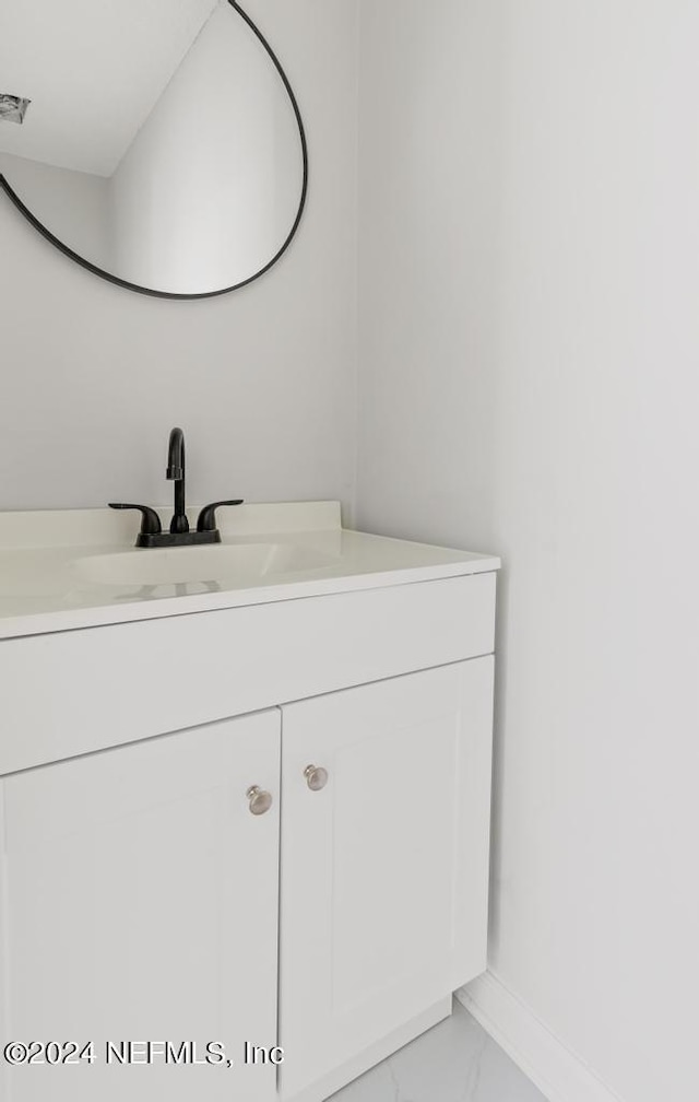 2619 Wrightson Dr, Jacksonville, FL 32223 - bathroom featuring baseboards, marble finish floor, and vanity