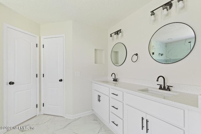 2619 Wrightson Dr, Jacksonville, FL 32223 - bathroom featuring a textured ceiling, marble finish floor, and a sink