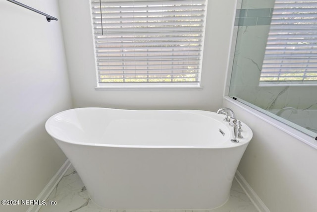 2619 Wrightson Dr, Jacksonville, FL 32223 - full bathroom featuring marble finish floor, a freestanding bath, and a healthy amount of sunlight