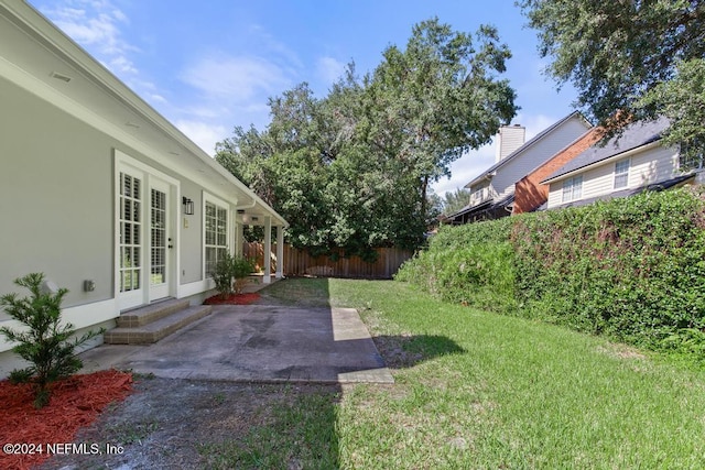 2619 Wrightson Dr, Jacksonville, FL 32223 - view of yard with a fenced backyard, french doors, and a patio