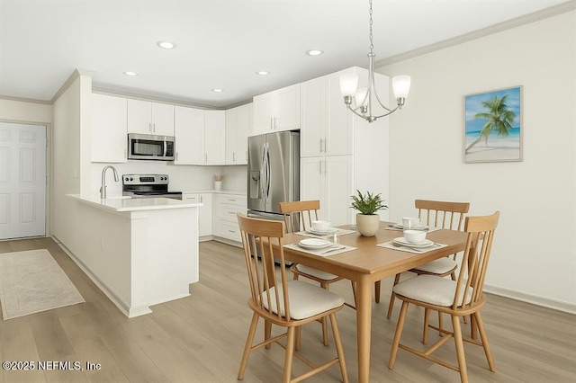 1601 Nectarine St Unit B2, Fernandina Beach, FL 32034 - dining space with ornamental molding, light wood-type flooring, recessed lighting, a chandelier, and baseboards