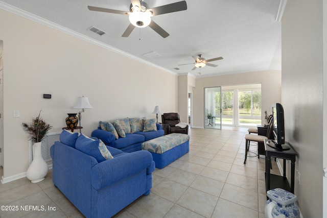 living room with light tile patterned floors, visible vents, a ceiling fan, and crown molding
