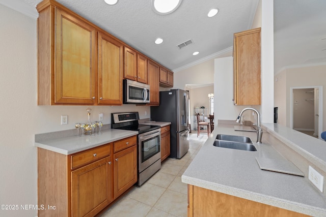 kitchen featuring a sink, stainless steel appliances, visible vents, and ornamental molding