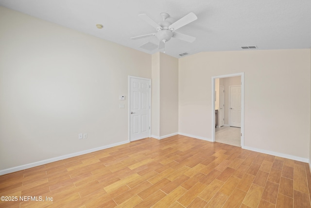 unfurnished room featuring vaulted ceiling, light wood-style floors, visible vents, and ceiling fan