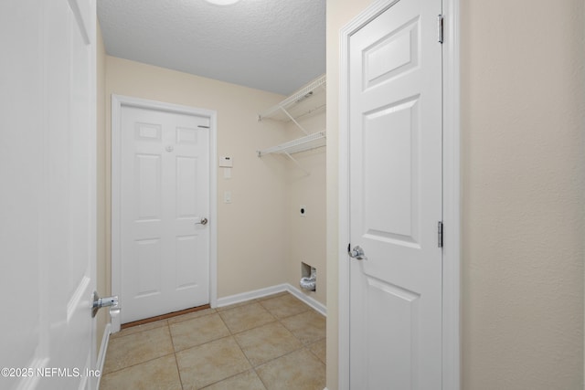 laundry room featuring baseboards, light tile patterned floors, laundry area, electric dryer hookup, and a textured ceiling