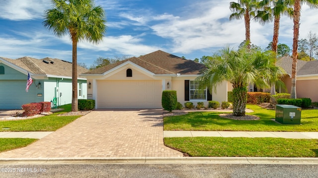 ranch-style home featuring stucco siding, decorative driveway, a garage, and a front yard