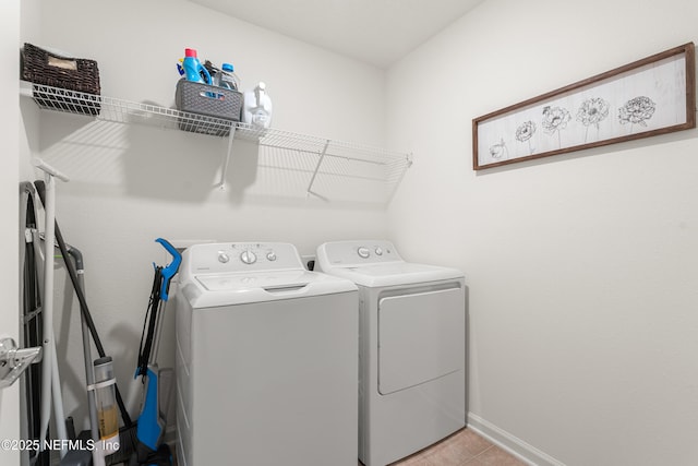 laundry area featuring laundry area, baseboards, and separate washer and dryer