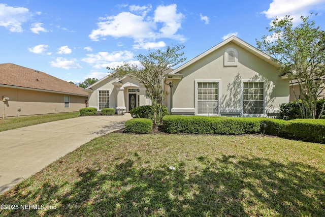 ranch-style house featuring stucco siding and a front lawn