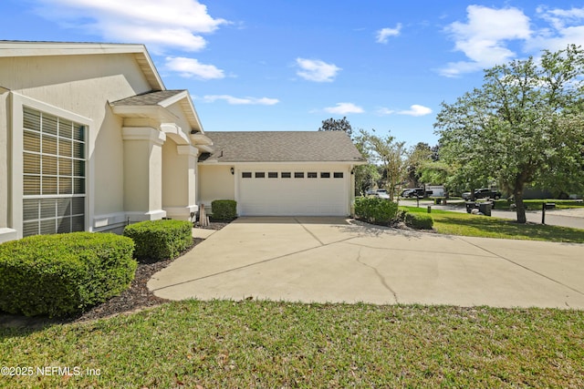 view of home's exterior featuring an attached garage, roof with shingles, concrete driveway, and stucco siding