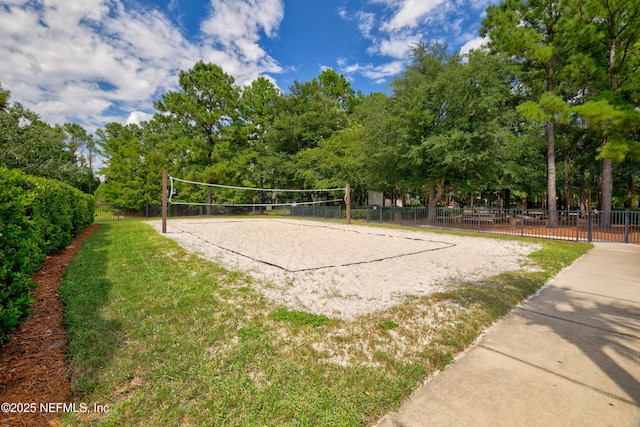 view of property's community featuring fence and volleyball court