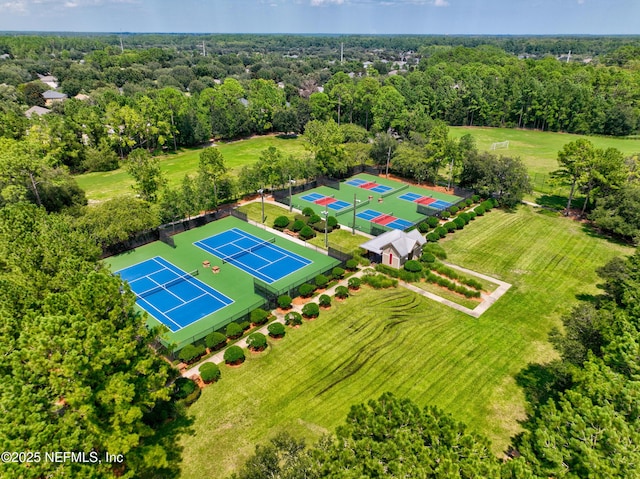 birds eye view of property featuring a view of trees