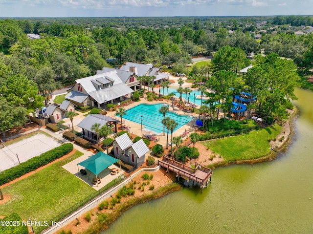 drone / aerial view with a wooded view and a water view