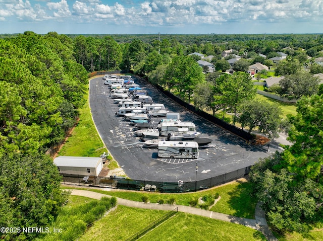 birds eye view of property featuring a forest view