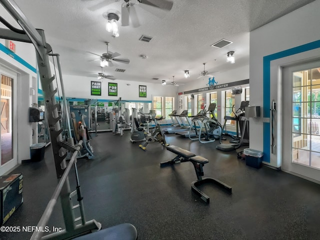 exercise room with a textured ceiling, a ceiling fan, and visible vents