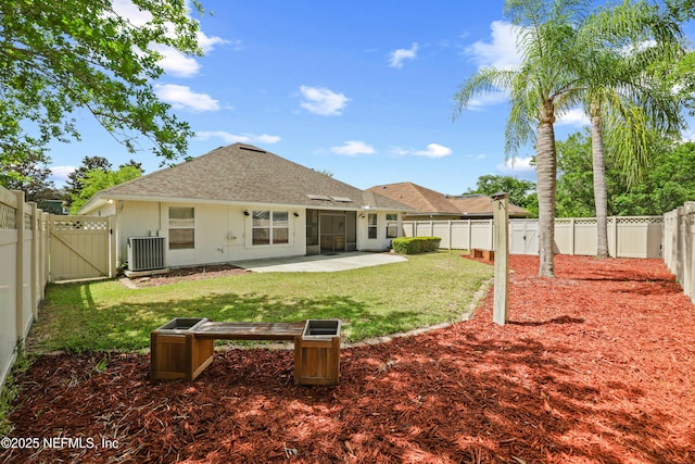 rear view of house with roof with shingles, a fenced backyard, a gate, and a patio
