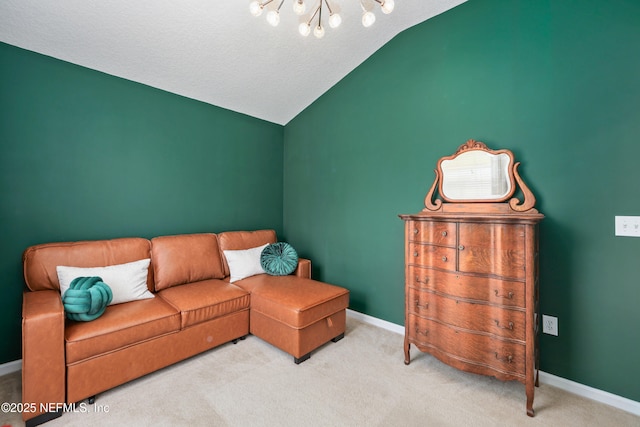 living area featuring a chandelier, lofted ceiling, baseboards, and carpet floors