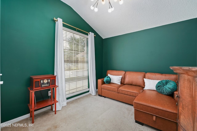carpeted living room with a chandelier, baseboards, lofted ceiling, and plenty of natural light