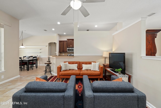 living room with ceiling fan, visible vents, recessed lighting, light tile patterned flooring, and baseboards