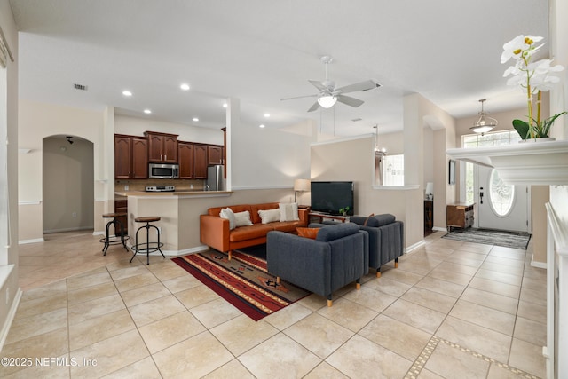 living area with light tile patterned flooring, a ceiling fan, visible vents, and recessed lighting