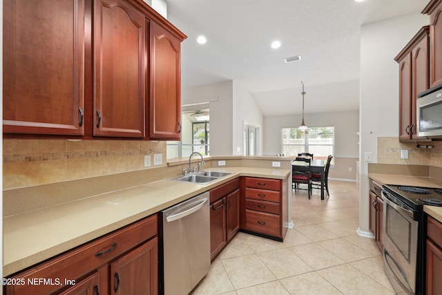 kitchen with light tile patterned floors, a peninsula, visible vents, appliances with stainless steel finishes, and a sink