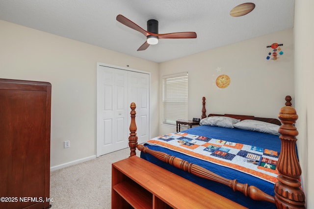 bedroom with a closet, ceiling fan, baseboards, and carpet floors