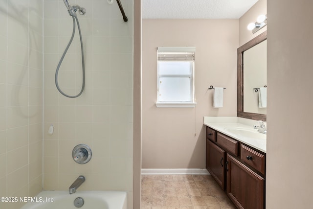 full bathroom with baseboards, a textured ceiling, vanity, and  shower combination