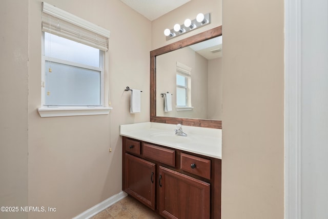 bathroom with vanity and baseboards