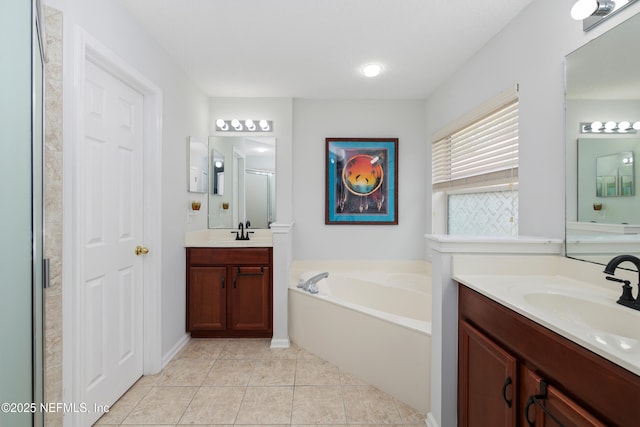 full bathroom featuring a bath, a stall shower, a sink, and tile patterned flooring