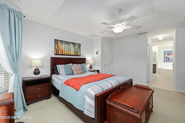 bedroom with visible vents, ensuite bathroom, baseboards, ceiling fan, and light carpet