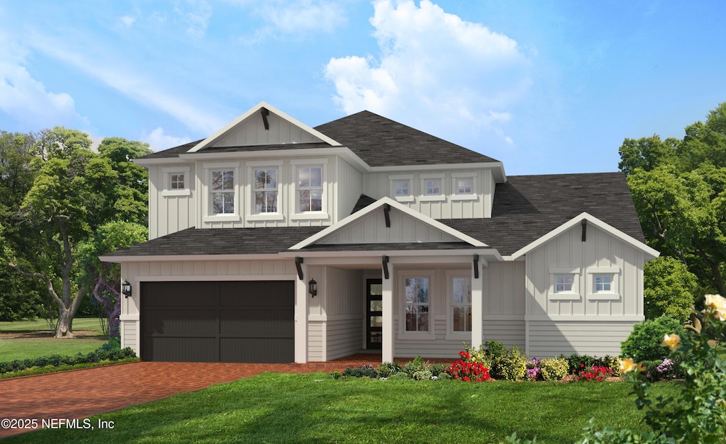 535 Courtney Chase Dr, Saint Augustine, FL 32092 - view of front of home with driveway, an attached garage, a shingled roof, a front lawn, and board and batten siding