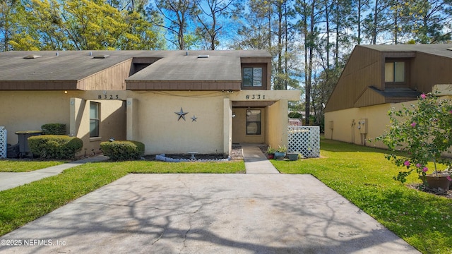 8331 Pineverde Ln, Jacksonville, FL 32244 - townhome / multi-family property with stucco siding and a front yard