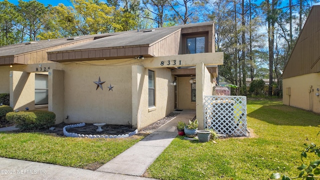 8331 Pineverde Ln, Jacksonville, FL 32244 - exterior space featuring a front lawn and stucco siding
