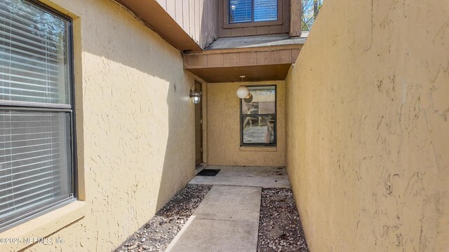 8331 Pineverde Ln, Jacksonville, FL 32244 - doorway to property featuring stucco siding