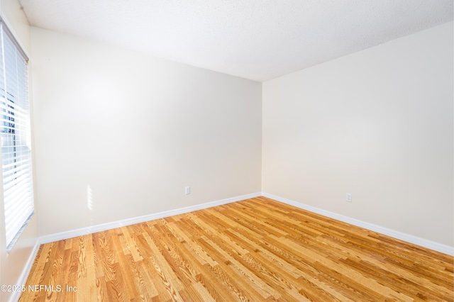 8331 Pineverde Ln, Jacksonville, FL 32244 - empty room with a textured ceiling, baseboards, and light wood-style floors