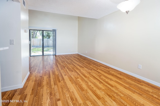 8331 Pineverde Ln, Jacksonville, FL 32244 - unfurnished room featuring visible vents, baseboards, a textured ceiling, and light wood finished floors