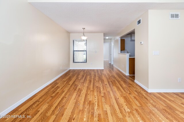 8331 Pineverde Ln, Jacksonville, FL 32244 - unfurnished dining area featuring visible vents, a textured ceiling, and light wood-type flooring