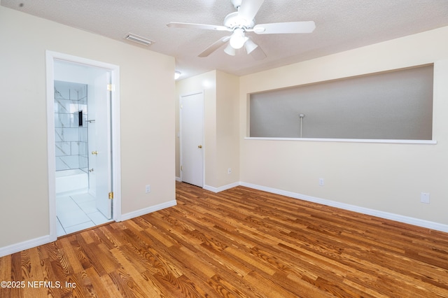 8331 Pineverde Ln, Jacksonville, FL 32244 - interior space featuring visible vents, wood finished floors, baseboards, and a textured ceiling