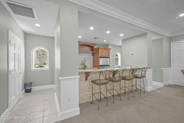 10075 Gate Pkwy Unit 1301, Jacksonville, FL 32246 - kitchen featuring visible vents, a healthy amount of sunlight, a breakfast bar, and stainless steel refrigerator