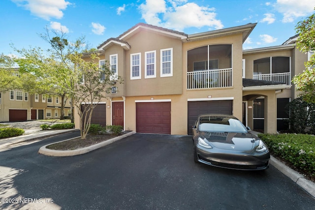 10075 Gate Pkwy Unit 1301, Jacksonville, FL 32246 - townhome / multi-family property with stucco siding, a garage, and driveway