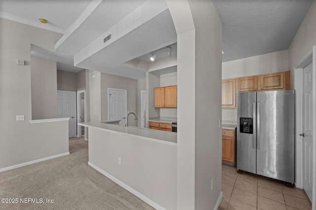 10075 Gate Pkwy Unit 1301, Jacksonville, FL 32246 - kitchen featuring visible vents, baseboards, light countertops, stainless steel refrigerator with ice dispenser, and a textured ceiling