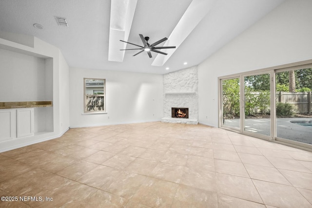 unfurnished living room with tile patterned flooring, visible vents, a fireplace, ceiling fan, and high vaulted ceiling