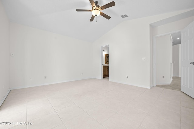 empty room with light tile patterned floors, a ceiling fan, lofted ceiling, and visible vents