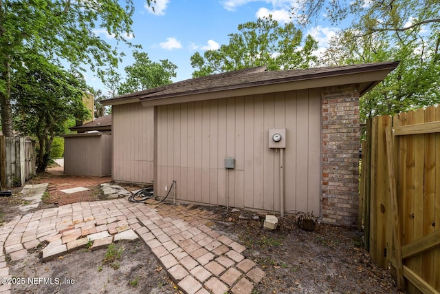 view of outbuilding with fence