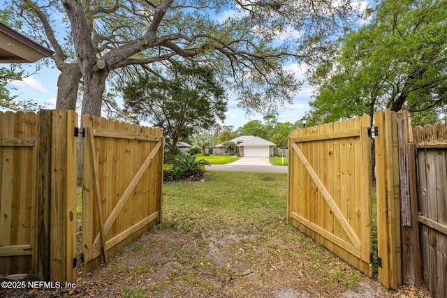 view of yard featuring fence and a gate