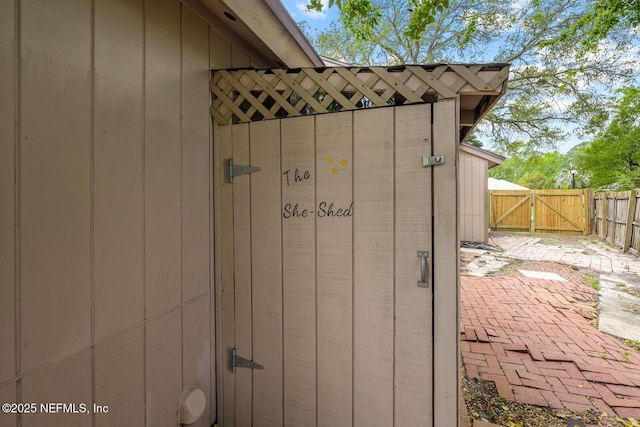 view of outbuilding with a gate and fence