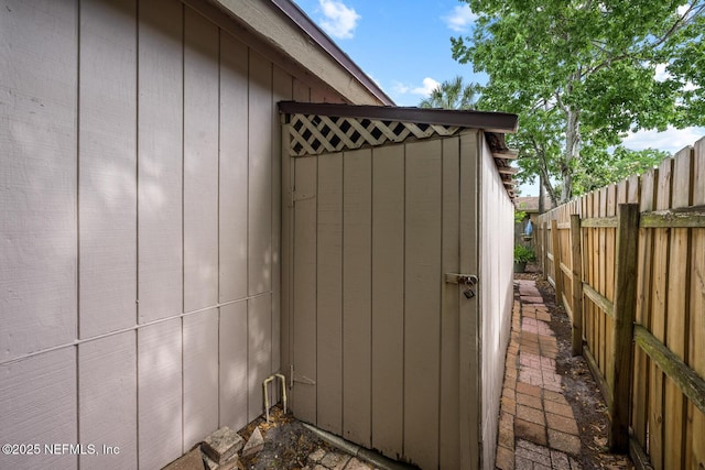 view of outbuilding featuring fence
