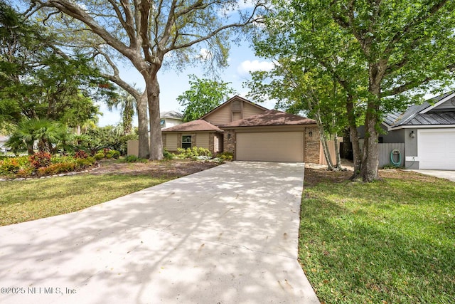 view of front facade with an attached garage, driveway, and a front lawn