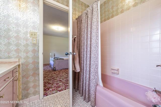 bathroom featuring wallpapered walls, shower / bath combo with shower curtain, vanity, tile patterned floors, and a textured ceiling