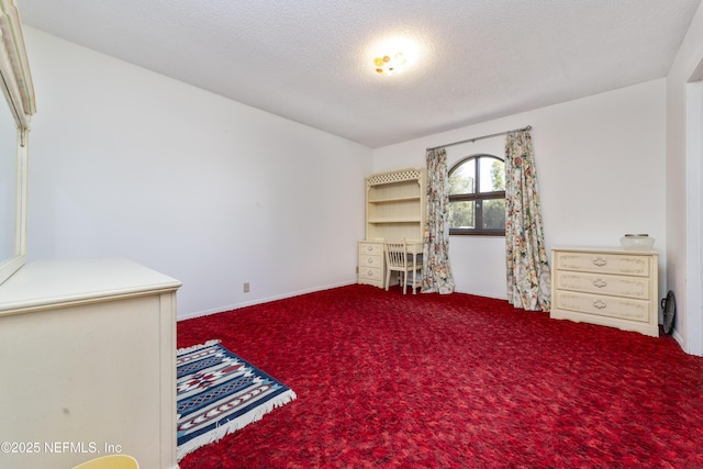 unfurnished room featuring carpet flooring and a textured ceiling